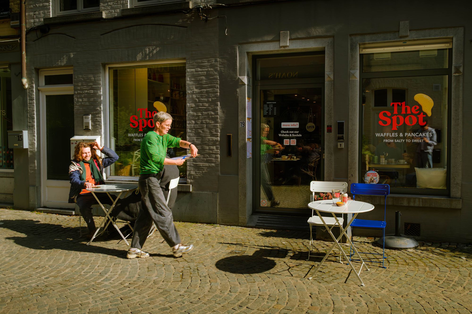 Sunlit café corner at TheSpot with tables set for brunch